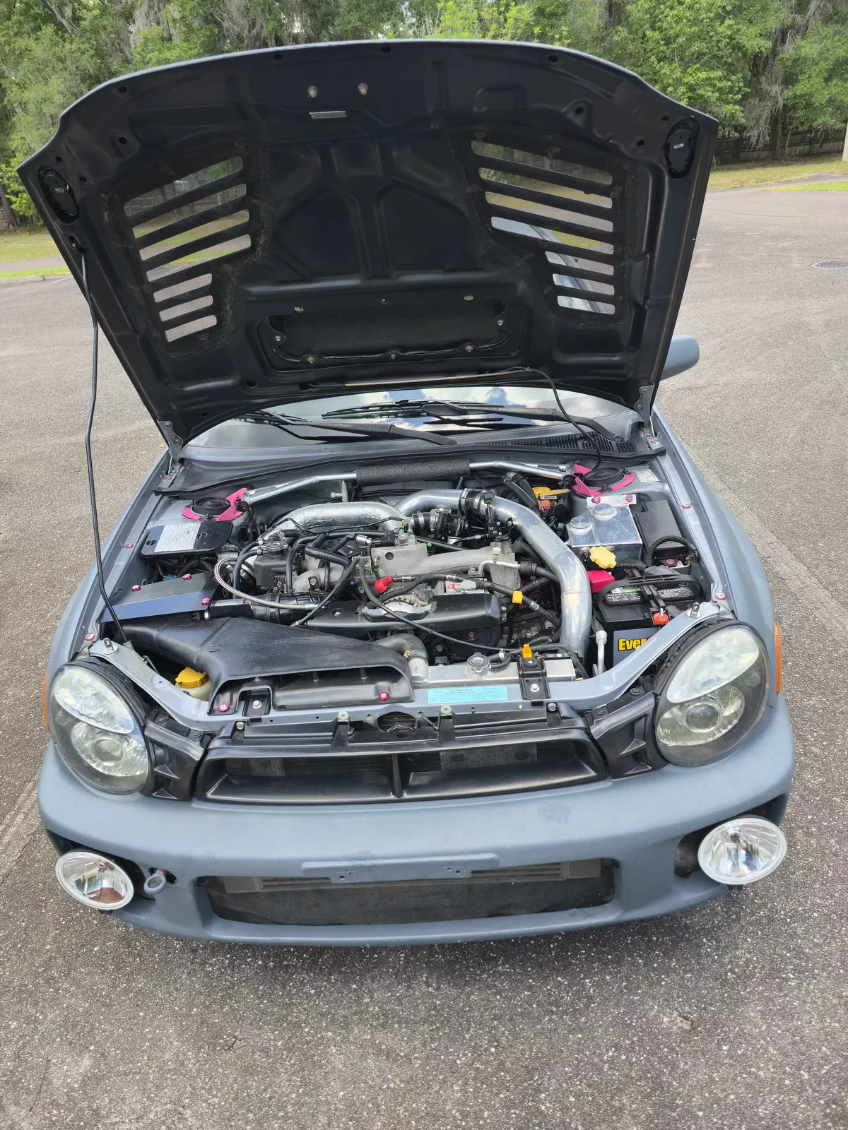 Front view showing FMIC, trans cooler, and carbon hood with AeroCatch latches
